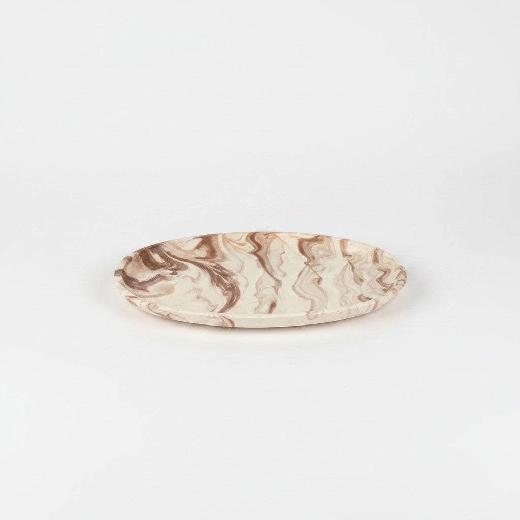 Solace & Smoke oval melamine serving tray with beige and brown marble pattern.