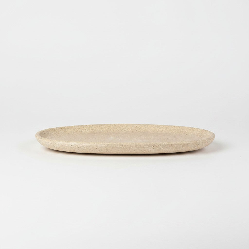Solace & Smoke oval serving tray in speckled beige melamine with a subtle marbled pattern.